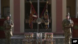 FILE - Soldiers stand guard at the NATO Resolute Support headquarters in Kabul, Afghanistan.