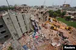 FILE - A view of rescue workers attempting to find survivors from the rubble of the collapsed Rana Plaza building in Savar, April 30, 2013.