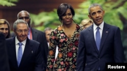 FILE - President Barack Obama and his wife Michelle arrive to attend a state dinner hosted by Cuban President Raul Castro (L), as part of Obama's three-day visit to Cuba.