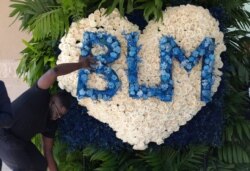Flowers are prepared and delivered to a public memorial for George Floyd at The Fountain of Praise church in Houston, MoJune 8, 2020, in Houston.