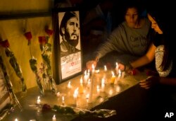 Students place candles around an image of the late Cuban leader Fidel Castro, at the university where Castro studied law as a young man, during a vigil in Havana, Cuba, Nov. 26, 2016.