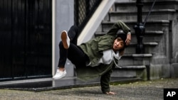 B-Girl Ayumi is a teacher by day but a world-class breakdancer by night. She poses here on October 31st 2017 (Little Shao/Red Bull Content Pool via AP Images)