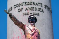 FILE - Paint and graffiti cover the Jefferson Davis Memorial in Richmond, Va., June 7, 2020, following a week of unrest in the U.S. against police brutality and racism in policing.
