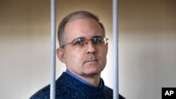FILE - Paul Whelan, a former U.S. marine, who was arrested for alleged spying in Moscow at the end of 2018, stands in a cage while waiting for a hearing in a court room in Moscow, Russia, Aug. 23, 2019.