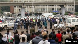 Bystanders watch the scene where Ethiopia's Grand Renaissance Dam Project Manager Simegnew Bekele was found dead in his car in Addis Ababa, Ethiopia July, 26, 2018.