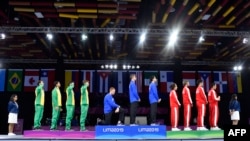 American fencer Race Imboden (4th from L) kneels during the national anthem at the Men's Foil Team medal ceremony in Fencing, at the Lima Convention Center during the Pan American Games Lima 2019, in Lima, Peru, Aug. 09, 2019. 