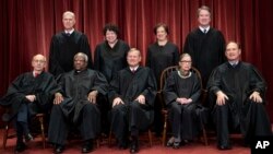 FILE - The justices of the U.S. Supreme Court gather for a formal group portrait at the Supreme Court Building in Washington, Nov. 30, 2018.