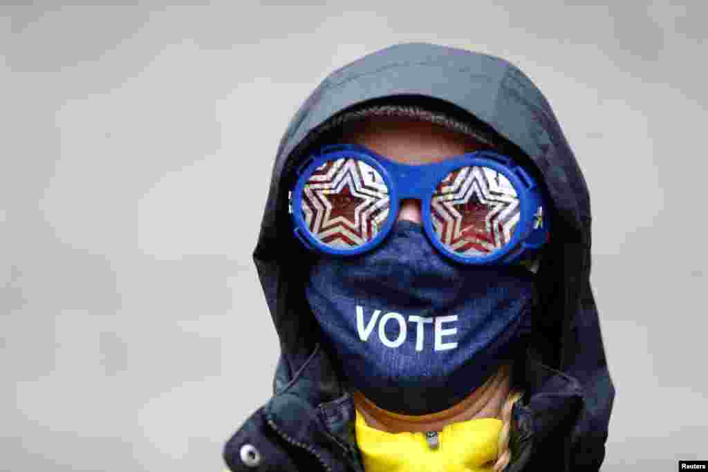 Cesia Kearns wearing glasses and a face mask is seen outside a polling place in the CenturyLink Field Event Center on Election Day, in Seattle, Washington, Nov. 3, 2020. 