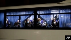 Buses carrying passengers from the quarantined Diamond Princess cruise ship leave a port in Yokohama, near Tokyo, Japan.