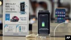 In this Sept. 8, 2016 photo, a Samsung Electronics' Galaxy Note 7 smartphone is displayed at the headquarters of South Korean mobile carrier KT in Seoul, South Korea.