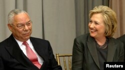 FILE - Former U.S. Secretaries of State Colin Powell (L) and Hillary Clinton (R) listen to remarks at a groundbreaking ceremony for the U.S. Diplomacy Center at the State Department in Washington, Sept. 3, 2014. 