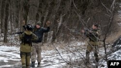 Separatis Pro-Rusia menanyai seorang laki-laki di Uglegorsk, Ukraina (19/2). Pemimpin Perancis dan Jerman menekankan pentingnya penghormatan terhadap gencatan senjata di wilayah Ukraina.