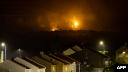 This picture taken from a position near Sderot along the Israeli border with the Gaza Strip early on Nov. 14, 2023, shows flares dropped by Israeli forces above the Palestinian territory.