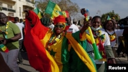 FILE - Supporters of Senegalese President Macky Sall march in support of him after he postponed presidential elections, in Dakar on Feb. 24, 2024. The election will now be held on March 24, following a ruling by the Constitutional Council on March 6.