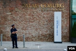 A guard stands outside the Palais Coburg Hotel, Vienna, Austria, June 27, 2015. (Brian Allen/VOA)