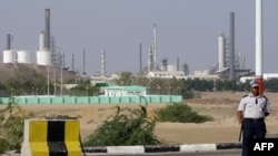 (File) A security guard keeps watch outside an oil refinery in the Yemeni southern city of Aden.