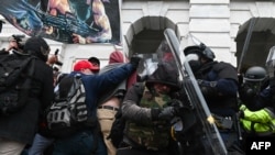 FILES - Riot police push back a crowd of supporters of then-President Donald Trump after they stormed the U.S. Capitol on January 6, 2021, in Washington.