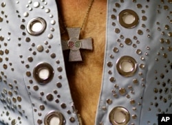 Jim Westover of Arizona City, Ariz., wears this medallion as he waits backstage before performing at the "Images of the King: Las Vegas" tribute artist contest in Las Vegas, July 15, 2017.