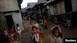 FILE - Ethnic Karen refugee children from Myanmar pass the time at the Mae La camp outside Mae Sot near the Thai-Myanmar border, Oct. 14, 2010. 