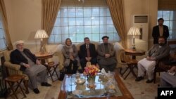 FILE - Members of Afghanistan's High Peace Council talk with delegates from the Hizb-e-Islami group (not pictured), during a meeting in Kabul, March 17, 2016.
