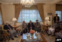 FILE - Members of Afghanistan's High Peace Council talks with delegates (not pictured) from the Hezb-e-Islami group, during a meeting in Kabul, March 17, 2016.