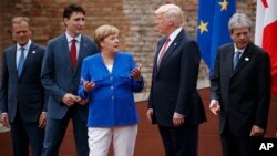 G7 leaders, from left, President of the European Commission Jean-Claude Junker, Canadian Prime Minister Justin Trudeau, German Chancellor Angela Merkel, President Donald Trump, and Italian Prime Minister Paolo Gentiloni, pose for a family photo at the Ancient Greek Theater of Taormina, May 26, 2017, in Taormina, Italy.