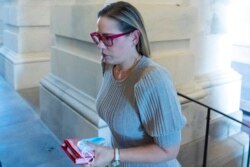 FILE - Sen. Kyrsten Sinema, D-Ariz., arrives for a vote on Capitol Hill, Nov. 1, 2021.
