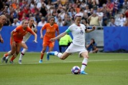 United States' Megan Rapinoe scores the opening goal from a penalty shot during the Women's World Cup final soccer match on July 7, 2019.