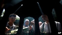 FILE - Muslims burn incense after attending an Eid al-Fitr morning prayer session at the Niujie Mosque in Beijing, August 8, 2013. China is said to be home to more than 20 million Muslims