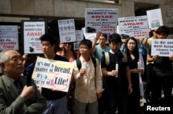 Ji Seong-ho, center, a North Korean defector living in South Korea and president of Now Action & Unity for Human Rights, attends a rally against Laos' recent repatriation of nine North Korean defectors, in front of the Laotian Embassy in Seoul.