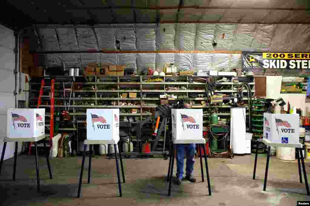 Voters cast their ballots at a polling station set up in a garage near Fernald, Iowa.