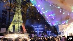 Shoppers visit the Christmas market along the Champs Elysees in Paris, December 3, 2011.