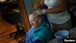 An Alzheimer's patient has her hair done in Mexico City in 2012