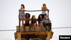 Israelis look at the Israel-Gaza border line as Palestinian protestors clash with Israeli soldiers April 6, 2018.