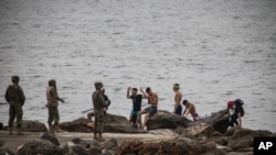 Spanish Army take positions as men mainly from Morocco, arrive into the Spanish territory next to the border of Morocco and Spain, at the Spanish enclave of Ceuta, on May 18, 2021. 