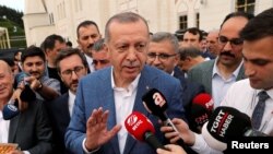 Turkish President Tayyip Erdogan talks to media after the Eid al-Fitr prayers to mark the end of the holy month of Ramadan in Istanbul, Turkey, June 4, 2019. 