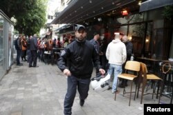 FILE - Israeli policemen at the scene of a shooting incident in Tel Aviv, January 1, 2016.