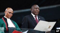 South African President Cyril Ramaphosa, right, takes the Oath of Office alongside Chief Justice, Mogoeng Mogoeng, at the Loftus Versfeld stadium in Pretoria, South Africa, May 25, 2019.