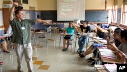 FILE — Teacher Xavier Chavez, standing, teaches a summer history class at Benson High School in Portland, Oregon.