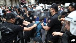 Police used tear gas to disperse the crowds and detained dozens of LGTBI activists as hundreds defied a ban and tried to stage a gay pride event in Istanbul, June 26, 2021.