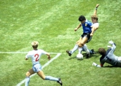 FILE - Argentina's Diego Maradona scores against England in the quarter final of the FIFA World Cup, Azteca Stadium, Mexico City, June 22, 1986. (Action Images via Reuters)