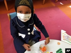 Amira Hassan, of Burnsville, Minnesota, plays in the waiting room at the specialty clinic at Children's Minnesota in Minneapolis, Minnesota, May 2, 2017.