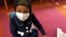 Amira Hassan, of Burnsville, Minnesota, plays in the waiting room at the specialty clinic at Children's Minnesota in Minneapolis, Minnesota, May 2, 2017. Amira went to the hospital's clinic for a routine wellness check, but had to wear a mask to protect her from measles after an outbreak.
