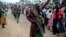 FILE - A Congolese army soldier responds to cheers from civilians as the army enters the town of Bunagana, eastern Congo, near the border with Uganda, Oct. 30, 2013. 