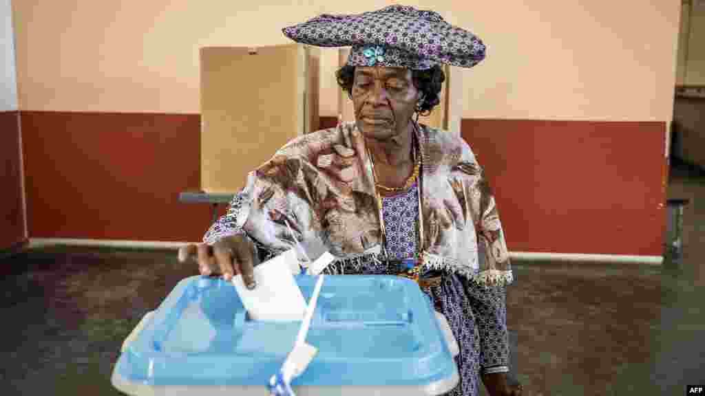 A woman casts her vote at a polling station in Windhoek, Namibia, during extended voting following the country's general election.
