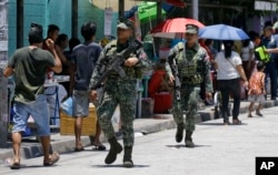 Philippine Marines secure a polling center during the country's midterm elections in Manila, Philippines on Monday, May 13, 2019.