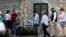 In this Friday, Feb. 28, 2020 photo, voters wait in line at an early polling site in San Antonio. California and Texas are the most populous states in the nation and the biggest delegate prizes for the candidates, yet they also present a stark…