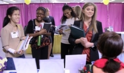 Martina Ryberg, right, of Plymouth State University talks with Tara Rossetti of On Call International during a 2012 job-finding event for college students in Manchester, New Hampshire.
