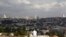 A view of Jerusalem is seen in the background as a man sits in Giv'at HaMatos, a neighborhood on the southern fringes of Jerusalem's city limits where Israel has decided to move forward on a settler housing project, Oct. 2, 2014. 
