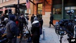 Members of the media report from outside the offices of the Tribeca Film Center, in New York, Thursday, Oct. 25, 2018. A New York City police bomb squad recovered a suspicious package addressed to Robert DeNiro. (AP Photo/Richard Drew)